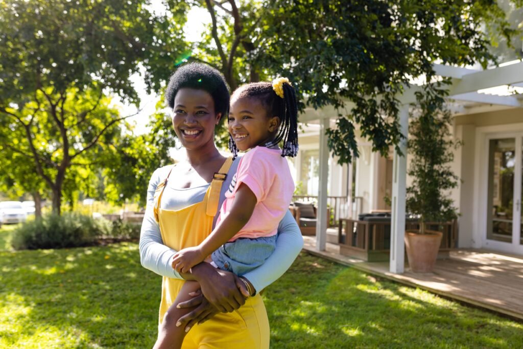 african-american-smiling-mother-carrying-daughter-2025-04-03-09-43-34-utc (1)