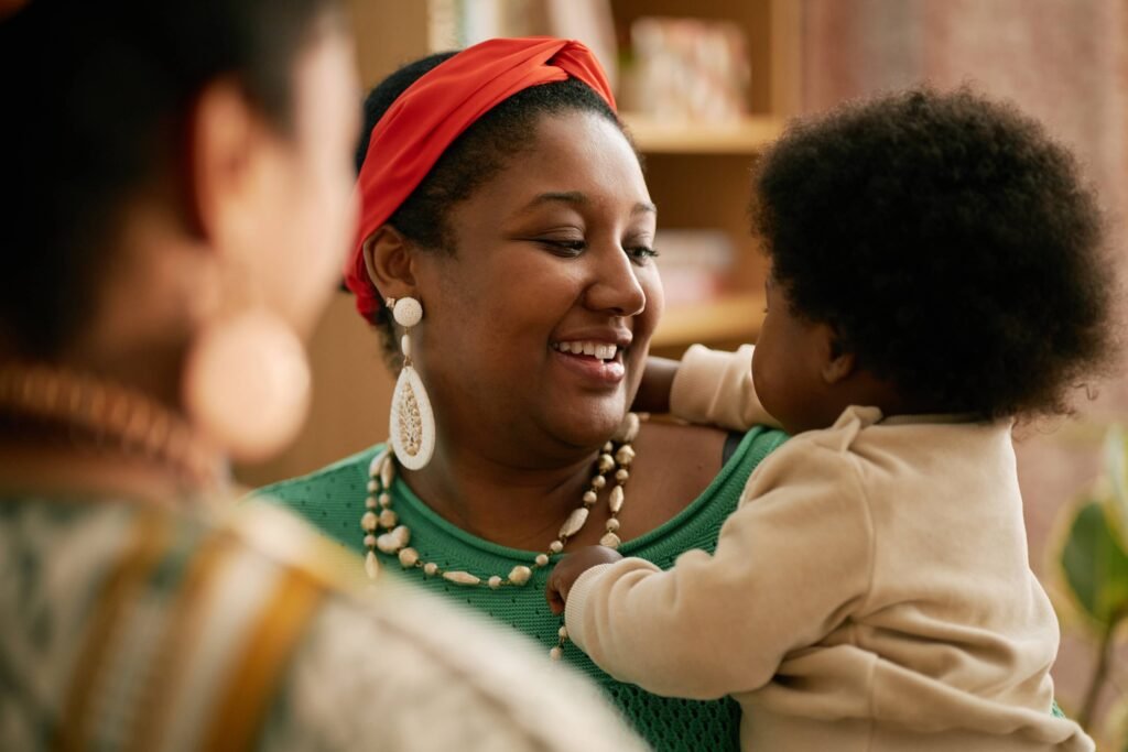 smiling-mother-holding-baby-while-chatting-with-fa-2025-05-31-23-26-19-utc (1)