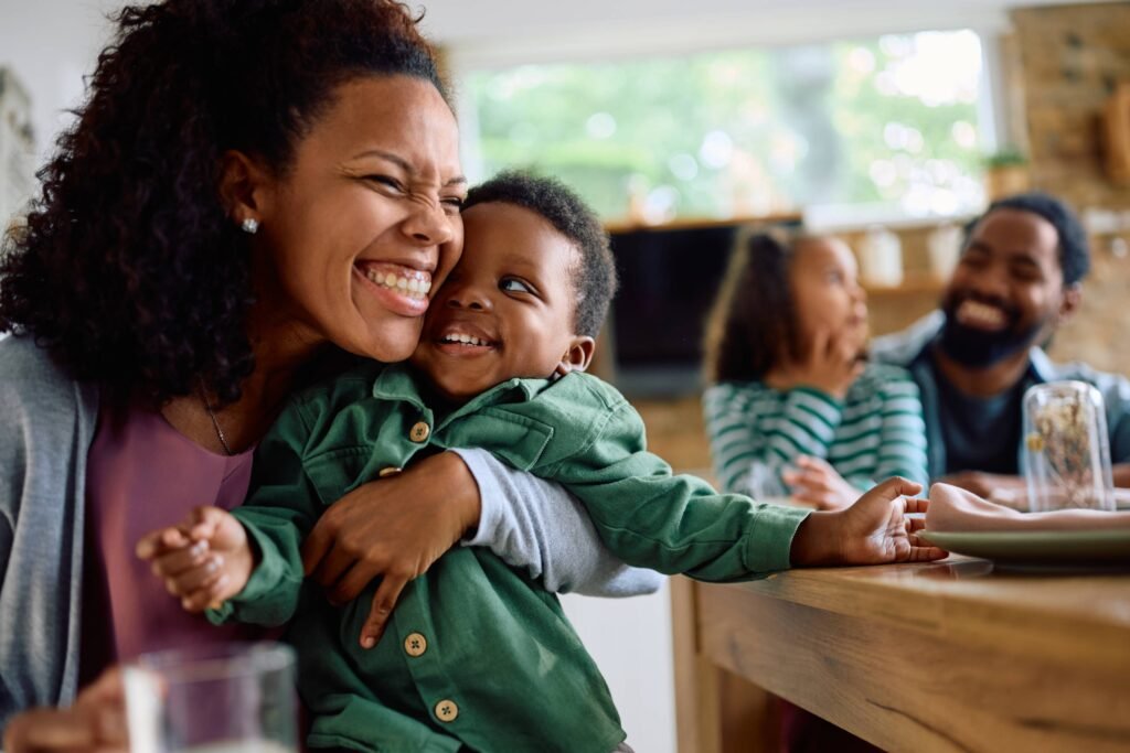 cheerful-black-mother-hugging-her-son-tightly-duri-2026-01-06-10-28-44-utc(1)