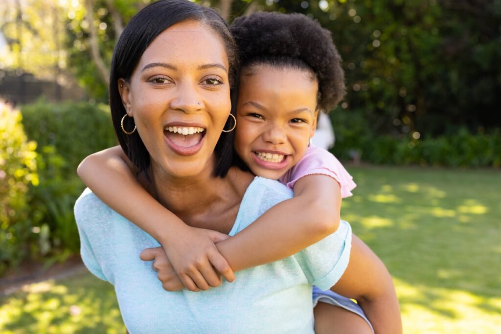 smiling-mother-giving-piggyback-ride-to-daughter-2026-01-09-09-26-30-utc(1)